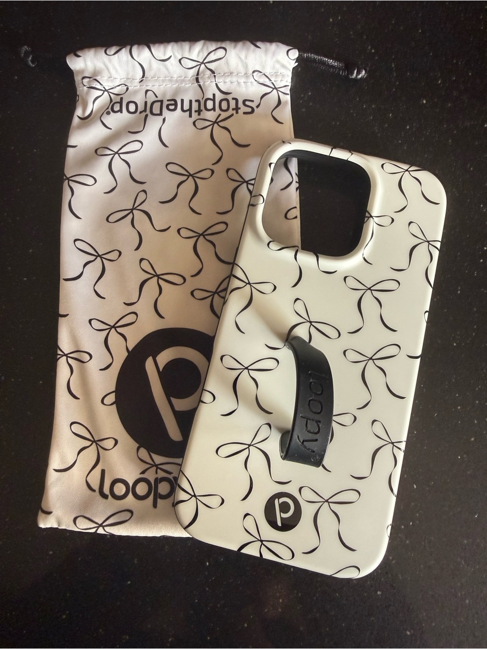 Loopy White Phone Case with Black Bow Pattern and Black Grip